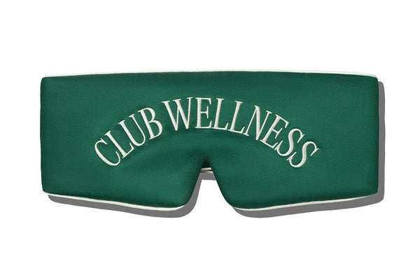 Green blockout sleep mask with 'Club Wellness' text on a white background