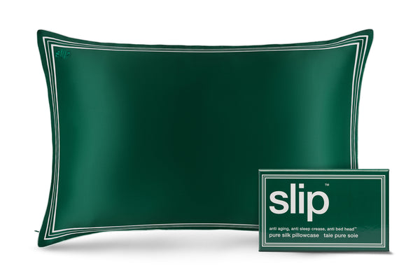 Green silk pillowcase with slip branded box on a white background