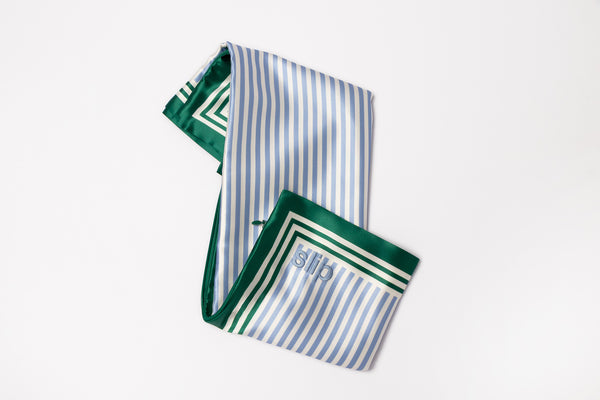 Green and white striped pure silk pillowcase with slip logo embroidered on a white background