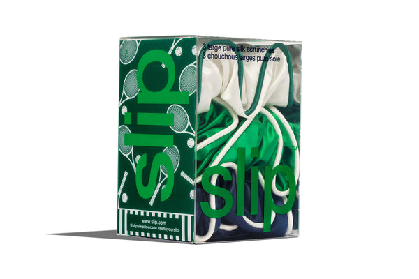Green and white packaging of slip large silk scrunchies on a white background