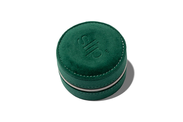 Complimentary green round suede leather case with zipper on a white background
