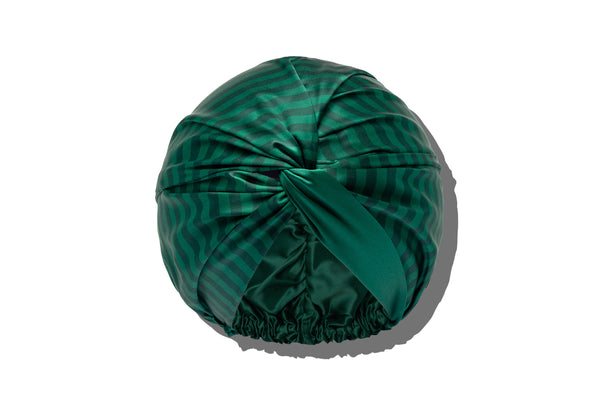 Green patterned pure silk turban / bonnet on a white background